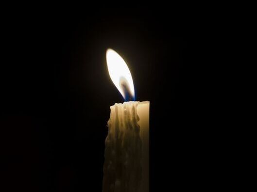 a candle blowing in the dark