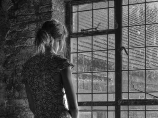 Woman looking through window, black and white, b&w,atmospheric